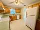 Functional kitchen with wooden cabinets, a double sink, and modern appliances including a large refrigerator at 111 S Delaware Ave, Deland, FL 32720