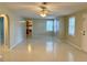 Bright living room with tile flooring, ceiling fan, and access to the kitchen at 111 S Delaware Ave, Deland, FL 32720