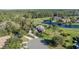 Aerial view of luxurious home with mature trees, golf course and pond at 1117 Oxbridge Ln, Ormond Beach, FL 32174