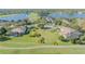Aerial view of landscaped homes, manicured green space, golf course and pond at 1117 Oxbridge Ln, Ormond Beach, FL 32174