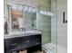 Modern bathroom featuring a walk-in shower with sleek fixtures and vanity mirror at 1117 Oxbridge Ln, Ormond Beach, FL 32174