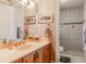 Well-lit bathroom with a single sink vanity, tiled walls, and glass-enclosed shower at 1117 Oxbridge Ln, Ormond Beach, FL 32174