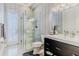 Modern bathroom featuring a walk-in shower, floating vanity, and bright natural light from the adjacent door at 1117 Oxbridge Ln, Ormond Beach, FL 32174