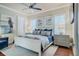 Cozy bedroom with a ceiling fan, comfortable bed, and serene natural light at 1117 Oxbridge Ln, Ormond Beach, FL 32174