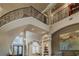 Grand foyer showcasing wrought iron staircase and soaring ceilings at 1117 Oxbridge Ln, Ormond Beach, FL 32174
