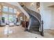 Grand foyer features a sweeping staircase with wrought iron detailing, high ceilings, and tile flooring at 1117 Oxbridge Ln, Ormond Beach, FL 32174