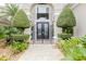 Ornate double doors with manicured landscaping at 1117 Oxbridge Ln, Ormond Beach, FL 32174