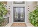 Elegant front door with glass detailing and surrounding landscaping at 1117 Oxbridge Ln, Ormond Beach, FL 32174