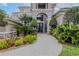 Stately home exterior showcases lush landscaping and a brick paver walkway at 1117 Oxbridge Ln, Ormond Beach, FL 32174