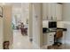 Hallway with built-in office, dining area, and natural light at 1117 Oxbridge Ln, Ormond Beach, FL 32174