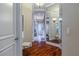 Hallway showcasing wooden floors and leading to other rooms and bathrooms at 1117 Oxbridge Ln, Ormond Beach, FL 32174