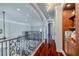 Upstairs hallway with hardwood floors and iron railing at 1117 Oxbridge Ln, Ormond Beach, FL 32174