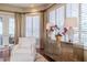 Bright living room features a decorative cabinet, plantation shutters and backyard views at 1117 Oxbridge Ln, Ormond Beach, FL 32174