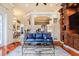 Spacious living room with elegant columns, hardwood floors, and a stylish blue sofa at 1117 Oxbridge Ln, Ormond Beach, FL 32174