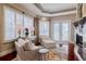 Airy living room showcasing ample seating, a fireplace and views of the backyard at 1117 Oxbridge Ln, Ormond Beach, FL 32174