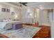 Spacious main bedroom featuring a large bed, wooden floors, and an ensuite bathroom at 1117 Oxbridge Ln, Ormond Beach, FL 32174