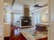 Spacious main bedroom boasts a fireplace, tray ceiling, and sitting area with bright, natural light at 1117 Oxbridge Ln, Ormond Beach, FL 32174
