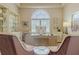 Bright home office with large window, display cabinet, and comfortable seating at 1117 Oxbridge Ln, Ormond Beach, FL 32174