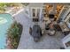 Aerial view of the outdoor kitchen with dining area, grill, fireplace, and access to the swimming pool at 1117 Oxbridge Ln, Ormond Beach, FL 32174