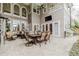 Expansive outdoor patio with dining area, seating, and a view of the lush landscaping at 1117 Oxbridge Ln, Ormond Beach, FL 32174