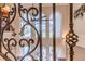 Close up of ornate railing, view to living room windows and ceiling fan at 1117 Oxbridge Ln, Ormond Beach, FL 32174