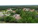 Aerial view of a quiet neighborhood featuring lush greenery and well-maintained homes at 115 San Marino Ln, Deland, FL 32724