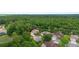 An aerial view of the home's location surrounded by mature trees in a tranquil neighborhood setting at 115 San Marino Ln, Deland, FL 32724
