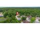 Aerial photograph pinpointing a property's location amidst lush trees within a quiet neighborhood at 115 San Marino Ln, Deland, FL 32724