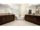 Luxury bathroom features double vanity with granite countertops and standalone tub at 115 San Marino Ln, Deland, FL 32724