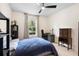 Bedroom features a ceiling fan, carpet flooring and view to the backyard at 115 San Marino Ln, Deland, FL 32724
