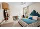 Bright bedroom showcasing stylish decor, a ceiling fan and a large window at 115 San Marino Ln, Deland, FL 32724