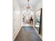 Spacious hallway with a gray runner rug, neutral walls, tile flooring, and modern lighting at 115 San Marino Ln, Deland, FL 32724