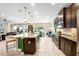 Open kitchen featuring granite countertops, stainless appliances, a center island, and views into the living area at 115 San Marino Ln, Deland, FL 32724