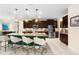 Spacious kitchen with dark wood cabinets, granite countertops, stainless steel appliances, and a large island at 115 San Marino Ln, Deland, FL 32724
