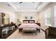 The primary bedroom features a tray ceiling, nightstands, an area rug, and lots of natural light at 115 San Marino Ln, Deland, FL 32724