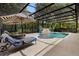 Inviting screened-in pool area features sun loungers and stone water feature at 115 San Marino Ln, Deland, FL 32724