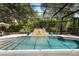 Relaxing screened-in pool area boasts in-ground pool with stone fountain feature at 115 San Marino Ln, Deland, FL 32724