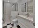 This bathroom features black and white checkerboard floors, glass shower, and floating vanity sink at 117 N Garfield Ave # 16, Deland, FL 32724