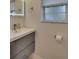 Bathroom with modern floating vanity, mirror, and frosted glass window at 117 N Garfield Ave # 16, Deland, FL 32724