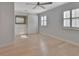 Bright bedroom features fan, closet with sliding doors, and natural light from two windows at 117 N Garfield Ave # 16, Deland, FL 32724