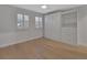 Neutral bedroom features hardwood floors, a ceiling fan, multiple windows and a wall bed at 117 N Garfield Ave # 16, Deland, FL 32724