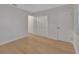 Bright bedroom with hardwood floors, neutral walls and two doors, one leading to a closet at 117 N Garfield Ave # 16, Deland, FL 32724