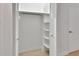 Bright closet with bi-fold doors showcasing a clothing rod and shelving for storage and organization at 117 N Garfield Ave # 16, Deland, FL 32724
