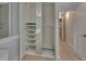 This is a view of a closet with pull out shelving, mirrored doors, and a look to the hallway at 117 N Garfield Ave # 16, Deland, FL 32724