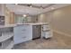 Open kitchen with stone tile flooring and stainless steel dishwasher, sink, and fixtures at 117 N Garfield Ave # 16, Deland, FL 32724