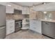 Modern kitchen features stainless appliances, white cabinets, and a pull-out corner shelf system at 117 N Garfield Ave # 16, Deland, FL 32724