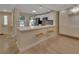 Bright kitchen features white cabinets, stainless steel appliances, breakfast bar, and two windows at 117 N Garfield Ave # 16, Deland, FL 32724