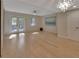 Light-filled living room with wood floors and French doors leading to an outdoor space at 117 N Garfield Ave # 16, Deland, FL 32724