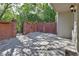 Private brick-walled patio offers a secluded outdoor space, perfect for relaxation and quiet enjoyment of the surrounding scenery at 117 N Garfield Ave # 16, Deland, FL 32724