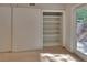 Walk-in closet with custom shelving and access to an outdoor patio through glass doors at 117 N Garfield Ave # 16, Deland, FL 32724